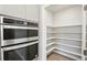 Walk-in pantry with ample shelving for food storage at 594 Fall River Ct, Brighton, CO 80601
