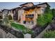 A well manicured backyard with lawn, grilling area and stone patio at 9441 Night Star Pl, Lone Tree, CO 80124