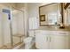 Modern bathroom features a glass enclosed walk-in shower, and a classic vanity with stone countertop and framed mirror at 9441 Night Star Pl, Lone Tree, CO 80124