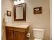 Bathroom featuring a vanity with framed mirror and commode with white fixtures at 9441 Night Star Pl, Lone Tree, CO 80124
