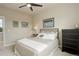 Neutral bedroom is well-lit with a view to the outside, and features dark-stained dressers and nightstands at 9441 Night Star Pl, Lone Tree, CO 80124