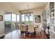 Bright dining room with hardwood floors, elegant lighting, and sliding glass doors to the outside at 9441 Night Star Pl, Lone Tree, CO 80124