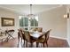 Cozy dining room featuring a chandelier, large windows, and comfortable seating for six at 9441 Night Star Pl, Lone Tree, CO 80124
