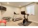 Dedicated home gym features a treadmill, exercise bike, free weights, and a wall-mounted TV for an invigorating workout at 9441 Night Star Pl, Lone Tree, CO 80124