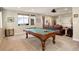 Spacious game room with a pool table, and a relaxing lounge area for entertaining friends and Gathering at 9441 Night Star Pl, Lone Tree, CO 80124