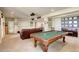 Entertain in this large game room with a pool table, wet bar, lounge area, and movie projector at 9441 Night Star Pl, Lone Tree, CO 80124