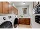 Convenient laundry room with washer and dryer, cabinets, and tile flooring at 9441 Night Star Pl, Lone Tree, CO 80124