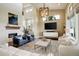 Spacious living room with a fireplace, area rug, ample natural light, and comfortable seating at 9441 Night Star Pl, Lone Tree, CO 80124