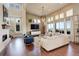 Bright and airy living room with hardwood floors, a fireplace, and large windows with a scenic view at 9441 Night Star Pl, Lone Tree, CO 80124