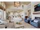 Open-concept living room featuring high ceilings, a fireplace, and modern decor at 9441 Night Star Pl, Lone Tree, CO 80124