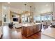 Spacious living room and kitchen area with hardwood floors and large windows offering scenic views at 9441 Night Star Pl, Lone Tree, CO 80124