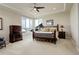 Spacious main bedroom with a tray ceiling, large windows, and a comfortable king-size bed at 9441 Night Star Pl, Lone Tree, CO 80124