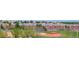 Panoramic view of the neighborhood showcasing green spaces, rows of townhomes, and walking paths at 9441 Night Star Pl, Lone Tree, CO 80124
