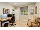 Bright home office featuring a comfortable chair, desk with monitors, and natural light at 9441 Night Star Pl, Lone Tree, CO 80124