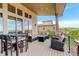 Large covered deck with cushioned seating, a bar table, and scenic views at 9441 Night Star Pl, Lone Tree, CO 80124