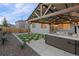 Backyard features a hot tub, pergola, artificial turf, rock landscaping, and fencing at 3844 Sandy Vista Ln, Castle Rock, CO 80104