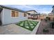 Backyard features a hot tub, pergola, artificial turf, rock landscaping, and fencing at 3844 Sandy Vista Ln, Castle Rock, CO 80104