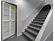 Carpeted stairs lead to the basement, featuring a storage cabinet with shelving and ample space at 3844 Sandy Vista Ln, Castle Rock, CO 80104