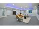 Finished basement with carpet floors features a brown sofa and recessed, color-changing ceiling lights at 3844 Sandy Vista Ln, Castle Rock, CO 80104