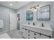 Stylish bathroom with sliding barn doors and white vanity offers dual sinks and modern fixtures at 3844 Sandy Vista Ln, Castle Rock, CO 80104