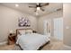 Bright bedroom with a ceiling fan, ensuite bathroom, and a window for natural light at 3844 Sandy Vista Ln, Castle Rock, CO 80104