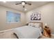 Comfortable bedroom featuring neutral decor, a ceiling fan, and a large window offering plenty of natural light at 3844 Sandy Vista Ln, Castle Rock, CO 80104