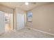 This bedroom features neutral carpet, a window, closet and access to another room at 3844 Sandy Vista Ln, Castle Rock, CO 80104