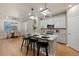 Modern kitchen with stainless steel appliances, quartz countertops, pendant lighting, and an adjacent dining area at 3844 Sandy Vista Ln, Castle Rock, CO 80104