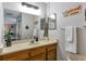 Functional bathroom with a spacious vanity, ample lighting, and a view into the adjacent bedroom at 14208 E 1St Dr # C1, Aurora, CO 80011