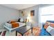 Bright bedroom featuring a cozy bed, a large window, and stylish decor at 14208 E 1St Dr # C1, Aurora, CO 80011