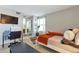 Comfortable bedroom with a desk, television, and access to an ensuite bathroom at 14208 E 1St Dr # C1, Aurora, CO 80011