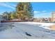 Exterior image shows parking area covered in snow with trees and homes in the background at 14208 E 1St Dr # C1, Aurora, CO 80011