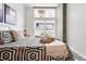 Bright bedroom featuring a large window and stylish geometric patterned bedding at 2518 16Th St, Denver, CO 80211