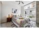 Sunlit bedroom with large window, patterned bedding, and modern decor for a tranquil retreat at 2518 16Th St, Denver, CO 80211