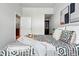 View of bedroom featuring neutral decor, patterned bedding, and an open closet space at 2518 16Th St, Denver, CO 80211