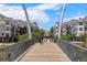 Modern pedestrian bridge framed by stylish apartments, inviting a stroll through the community at 2518 16Th St, Denver, CO 80211