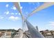 A pedestrian bridge features unique architectural design elements against a vibrant blue sky at 2518 16Th St, Denver, CO 80211