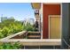 Modern condo entrance showing landscaping and a distant view of the Denver cityscape at 2518 16Th St, Denver, CO 80211