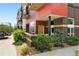 Modern condo with red siding, brick accents, and landscaped entrance, offering urban living at 2518 16Th St, Denver, CO 80211