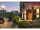 Modern condo building with city views, red siding, and landscaped entrance at dusk at 2518 16Th St, Denver, CO 80211