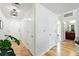 Bright hallway with neutral paint, wood floors, and access to a full bathroom at 2518 16Th St, Denver, CO 80211