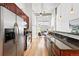 Sleek kitchen with stainless steel appliances and dark wood cabinetry in open layout at 2518 16Th St, Denver, CO 80211