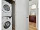 Laundry area featuring a stacked washer and dryer, conveniently located near the bathroom at 2518 16Th St, Denver, CO 80211