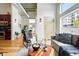 Open-concept living room with hardwood floors, modern lighting, and easy access to the kitchen at 2518 16Th St, Denver, CO 80211
