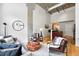 Open-concept living room with concrete ceilings, hardwood floors, and abundant natural light at 2518 16Th St, Denver, CO 80211