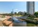 Modern apartments overlook a scenic riverfront with walkable paths and lush landscaping at 2518 16Th St, Denver, CO 80211