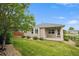 Well-maintained backyard featuring lush green grass, mature trees, and a cozy patio at 11847 Trail View Ln, Parker, CO 80134