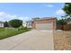 Inviting single-story home with brick accents, a two-car garage, and a concrete driveway at 11847 Trail View Ln, Parker, CO 80134