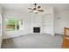Cozy living room features a fireplace, large window, and a ceiling fan at 11847 Trail View Ln, Parker, CO 80134