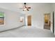 Bright main bedroom with ceiling fan, a walk-in closet, and neutral carpet at 11847 Trail View Ln, Parker, CO 80134